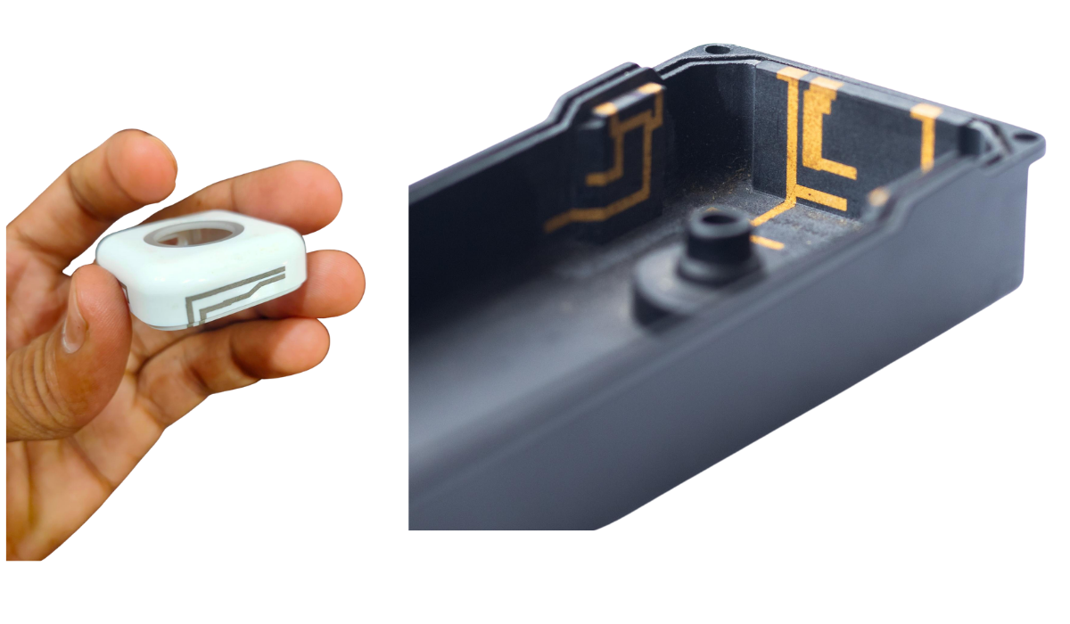 LDS antenna examples on a small white component held in a hand and a dark plastic housing